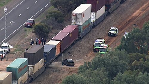 A witness heard the train honk, and then 'bang'. The man's car flipped on impact. (9NEWS)