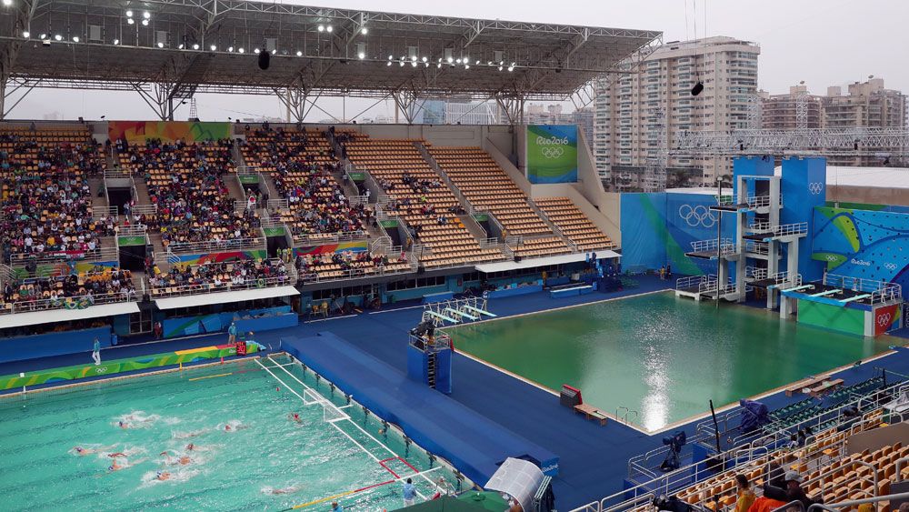 The water polo pool (left) is starting to turn the colour of the diving pool.(Getty)