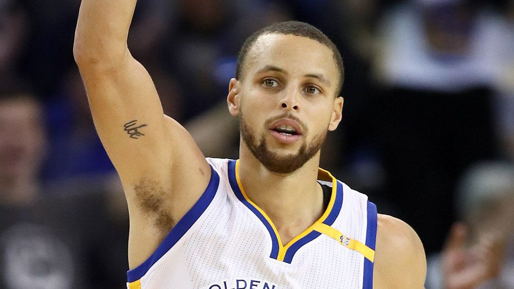 Curry sparks rout with half-court shot