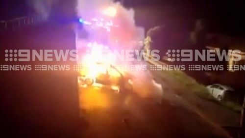 The car slammed into a power pole, causing it to split and catch fire. (9NEWS)