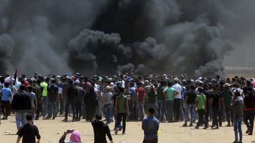 Palestinian protesters burn tires near the Israeli border fence, east of Khan Younis, in the Gaza Strip