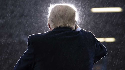 Donald Trump speaking a snowy rally in Lansing, Michigan.