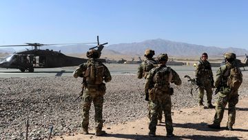 Australian Special Operations Task Group Soldiers move towards waiting UH-60 Blackhawk helicopters, in Afghanistan.