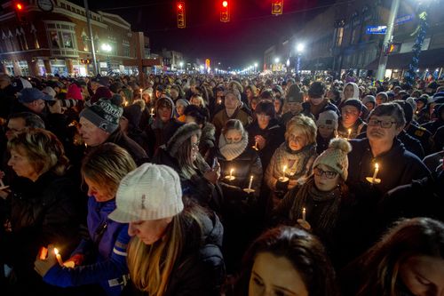 Thousands gather alongside the Oxford community as they seek healing and comfort during a candlelight vigil on Friday, Dec. 3, 2021 along Washington Street in downtown Oxford.