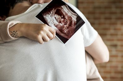 pregnant couple with ultra sound photo
