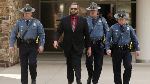 Arkansas State Troopers escort former Lonoke County sheriff's deputy Michael Davis (left center) after being convicted of negligent homicide on Friday, March 18, 2022, at the Cabot Readiness Center in Cabot.  (Arkansas Democrat-Gazette/Thomas Metthe)