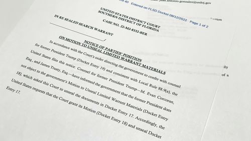 The notice filed by the Justice Department to the U.S. District Court South District of Florida informing the judge that lawyers for former President Donald Trump did not object to the government's motion to unseal the search warrant for Trump's Mar-a-Lago estate, is photographed Friday, Aug. 12, 2022. (AP Photo/Jon Elswick)