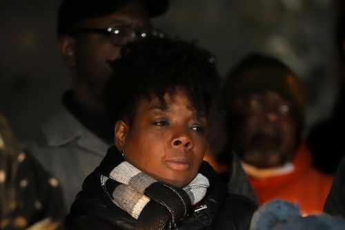 A woman cries during a candlelight vigil for Tyre Nichols, who died after being beaten by Memphis police officers, in Memphis, Tenn., Thursday, Jan. 26, 2023 