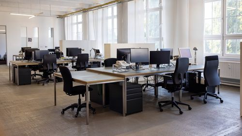 Open plan startup office. Coworking desks in a brightly lit office space.