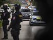 Policemen guard the area as convoy brings the suspect, in shooting of Slovakia&#x27;s Prime Minister Robert Fico, to court in Pezinok, Slovakia, Saturday, May 18, 2024.