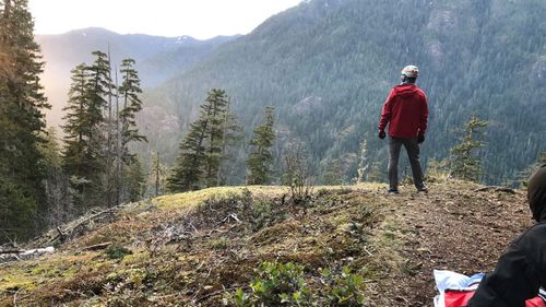 A rescuer is photographed waiting for the helicopter to take Mr Oldendorf from the mountain.