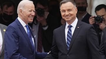 US President Joe Biden, left, and Polish President Andrzej Duda shake hands during a military welcome ceremony at the Presidential Palace in Warsaw, Poland, on Saturday, March 26, 2022. 