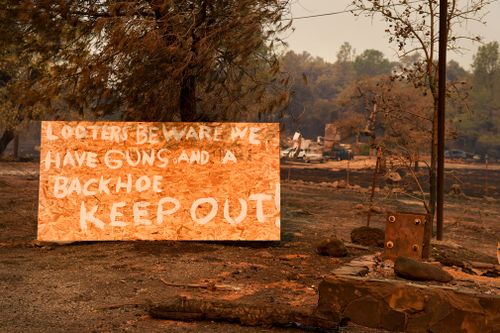 A sign on Highway 191 in Paradise warns looters to stay away after the Camp Fire destroyed the town