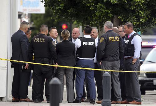 Authorities say two police officers and a suspect were shot after reports of a man with a sword entering the Church of Scientology in Inglewood.(AP Photo/Reed Saxon)