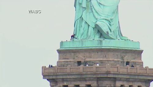 A group of protesters were arrested before the climber scaled the statue. Picture: Supplied