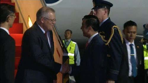 Scott Morrison shaking the hand of his government escort upon arrival. 
