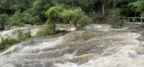 Cascading water is seen in the Gympie region, amid fears the city could be split in two if more rain falls.