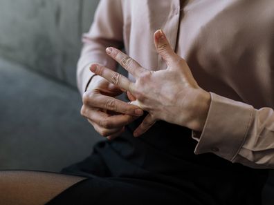 Stock photo of a woman removing her wedding ring, divorce.