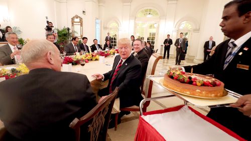 Donald Trump is treated to an early birthday cake whilst in Singapore ahead of the historic summit with North Korean leader Kim Jong-Un. (Getty)