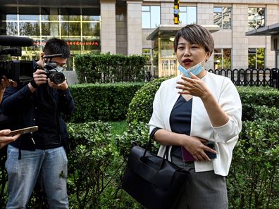 Teresa Xu, also known as Xu Zaozao, speaks to journalists at Chaoyang People's Court before a court hearing in her suit against a Beijing hospital for refusing to freeze her eggs because she is unmarried in Beijing on September 17, 2021. (Photo by Jade GAO / AFP) (Photo by JADE GAO/AFP via Getty Images)