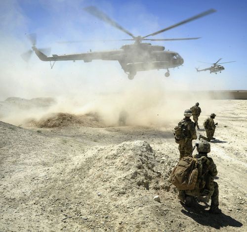 Australian Defence Force, members of the National Interdiction Unit  and the Special Operations Task Group await the arrival of two Mi-17 helicopters in Kandahar, Afghanistan.