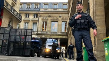Police forces set up a barricade in front of the Constitutional Council Friday, April 14, 2023 in Paris.