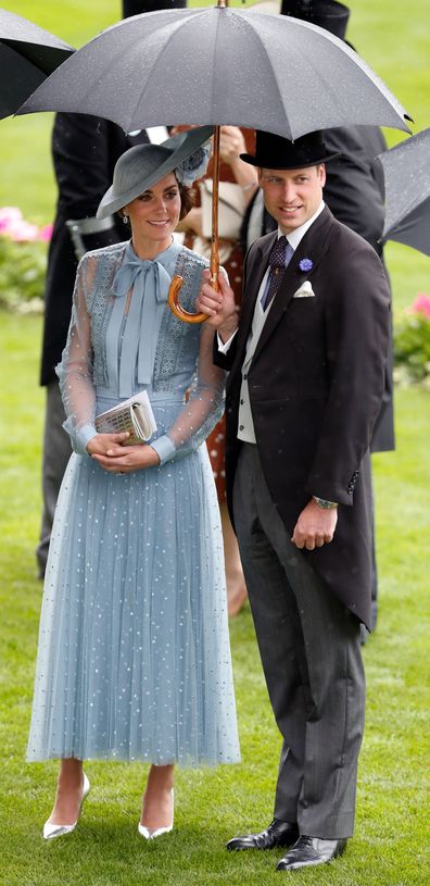 Prince William and Kate Middleton shelter under an umbrella at Royal Ascot