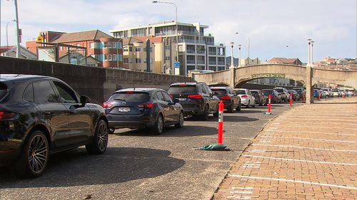 Dozens of people in cars lined up at the drive-through clinic.