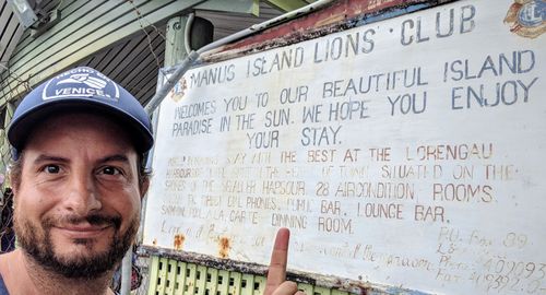 Dan Ilic at the Manus Island welcome sign.