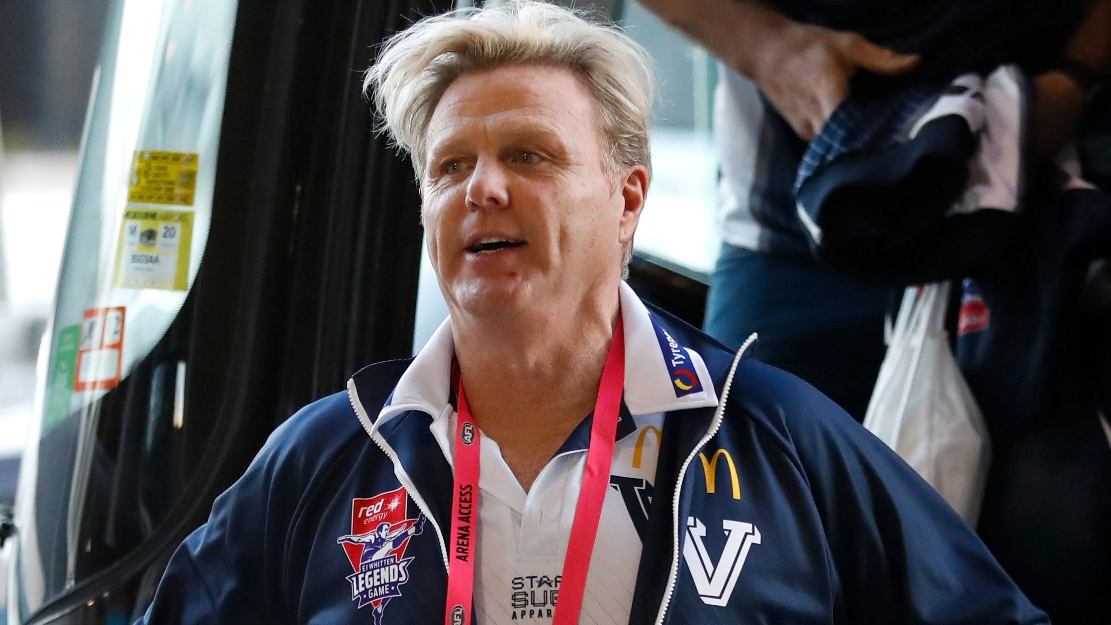 Dermott Brereton, pictured walking off the bus as coach of Victoria for a 2019 match.