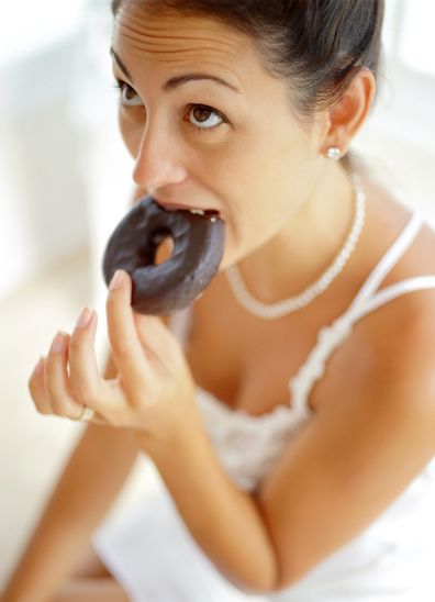 Bride eating chocolate donut