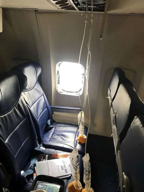 Oxygen masks and a blown out window are seen from inside a Southwest Airlines plane after an emergency landing at the Philadelphia airport, April 17, 2018. (Picture: Marty Martinez)