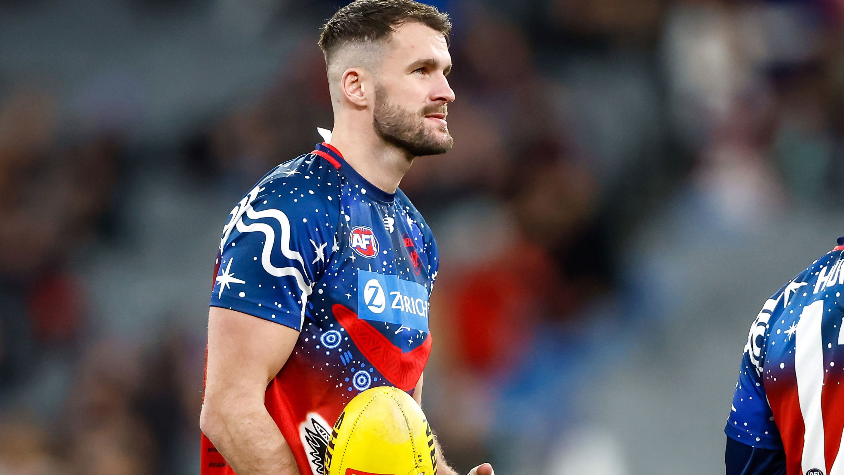 Joel Smith of the Demons warms up before their round 18 match against the Brisbane Lions. 