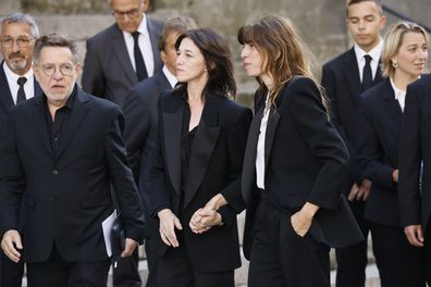 ane Birkin's daughters Charlotte Gainsbourg, center, and Lou Dillon, center right, arrive to Jane Birkin's funerals ceremony at the Saint-Roch church in Paris, Monday, July 24, 2023. Actor and singer Jane Birkin, who made France her home and charmed the country with her English grace, natural style and social activism, has died last week at age 76. (AP Photo/Thomas Padilla)