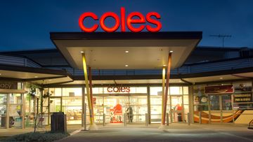 Sydney, Australia - July 25, 2013: The entrance to a brightly lit Coles supermarket in Ropes Crossing at dusk.