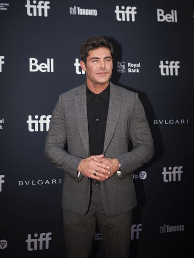 Zac Efron posed for a photo on the red carpet for the film, "Best run beer ever," at Roy Thomson Hall during the Toronto International Film Festival, 2022.