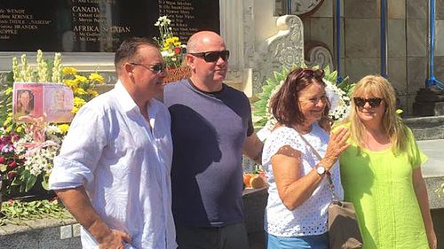 Andrew Csabi with fellow survivor Anthony McKay in front of the Bali bombing memorial. (Facebook)