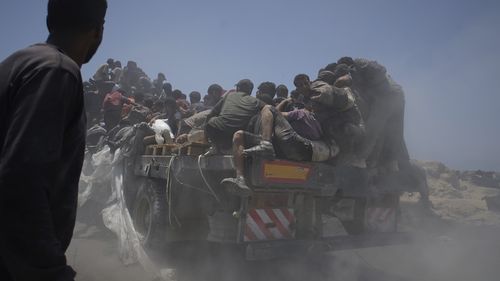FILE - Palestinians hold onto an aid truck returning to Gaza City from the northern Gaza Strip on Tuesday, July 22, 2025. (AP Photo/Jehad Alshrafi, file)