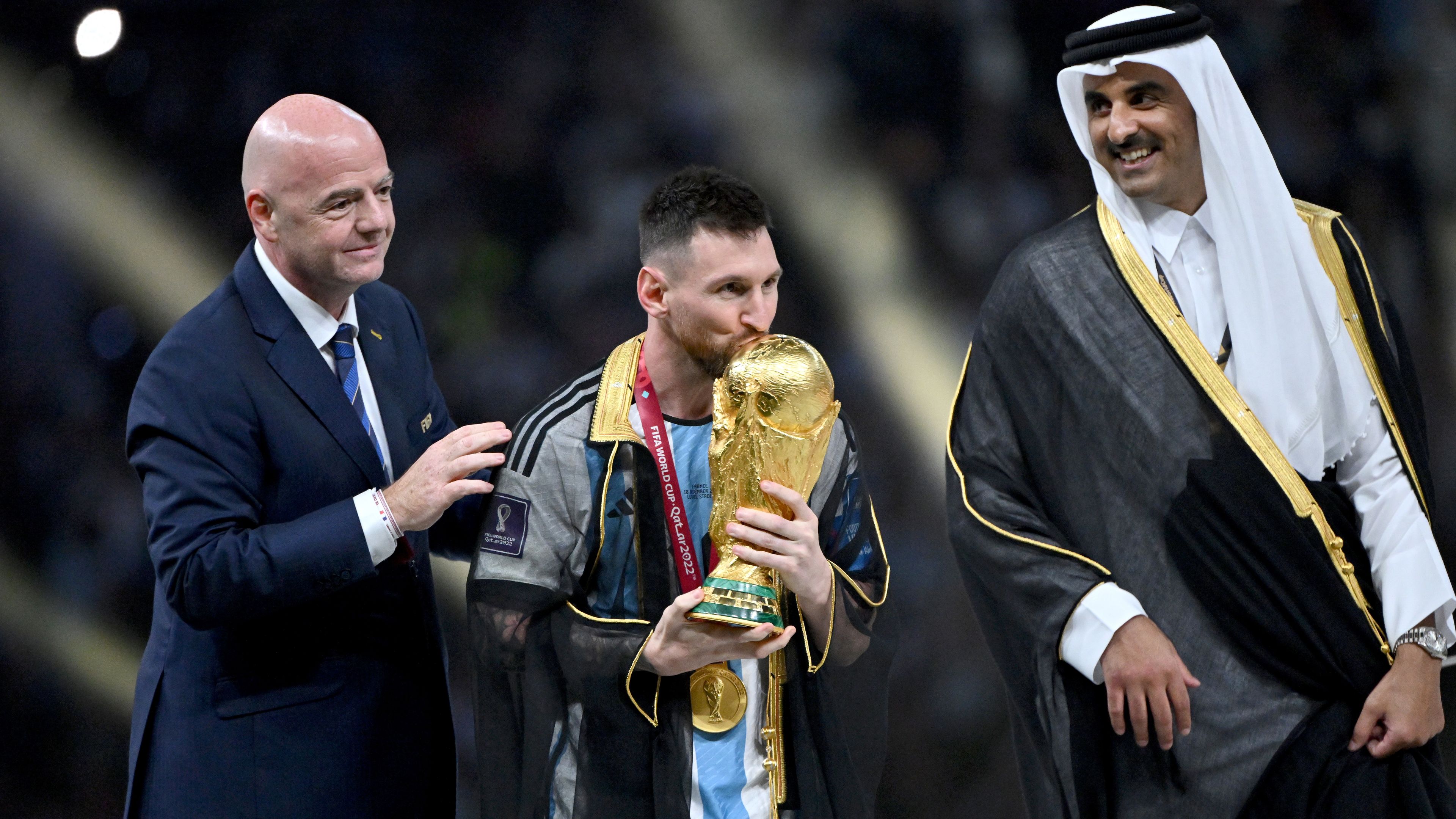 Lionel Messi of Argentina kisses the FIFA World Cup.