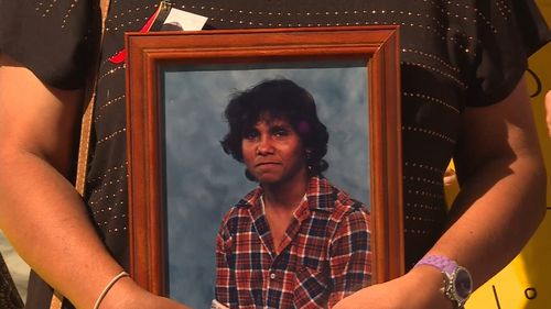One person held a picture of Mark Haines who died in 1988. (9NEWS)