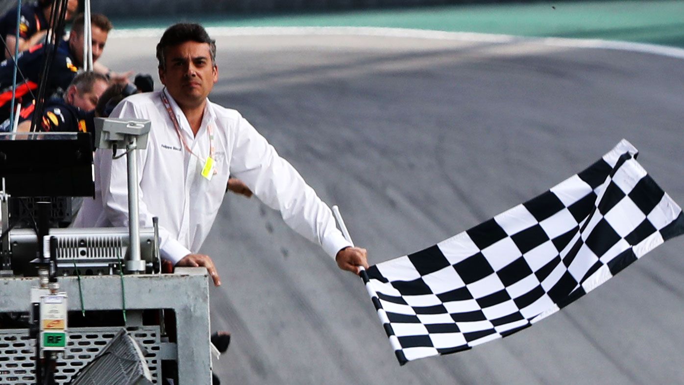 The chequered flag is waved during the F1 Grand Prix of Brazil