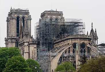 When was Notre-Dame de Paris' spire destroyed by fire?