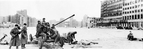 Soviet troops man an anti-aircraft gun in one of the squares of Kharkov, Ukraine steel center, after the Red Army retake the city from the Germans in Feb. 1943 during World War II.  The House of Industry is in the background.  (AP Photo)