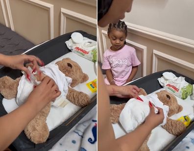 Cardi B changes diaper on teddy bear. 