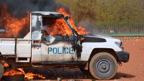 A police truck set on fire by protesters in a demonstration against Charlie Hebdo in Niamey. (Getty)