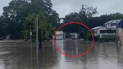 Millward captured a bizarre sight as kegs floated down floodwaters, on what once was a street. 