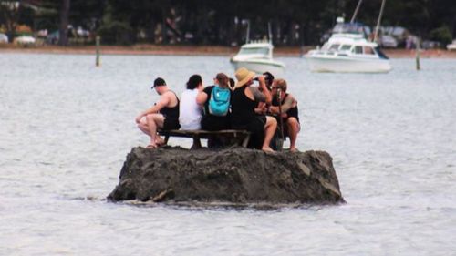 The group appear to have set up a picnic table and drink cooler and are enjoying a few beverages. (Facebook/David Saunders)