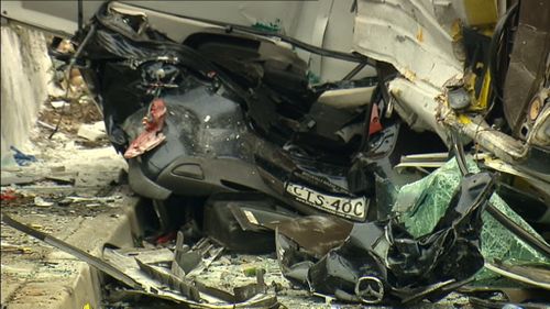 A woman was trapped in the wreckage for almost 90 minutes. (9NEWS)