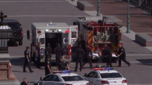 The suspect being loaded into an ambulance. (NBC)