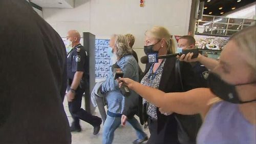 Peter Foster arrived at Brisbane airport surrounded by police and in handcuffs.